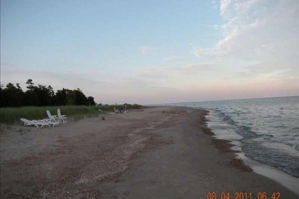 [Image: At the Lake Lake Michigan Cape Cod Home with Sand Beach]